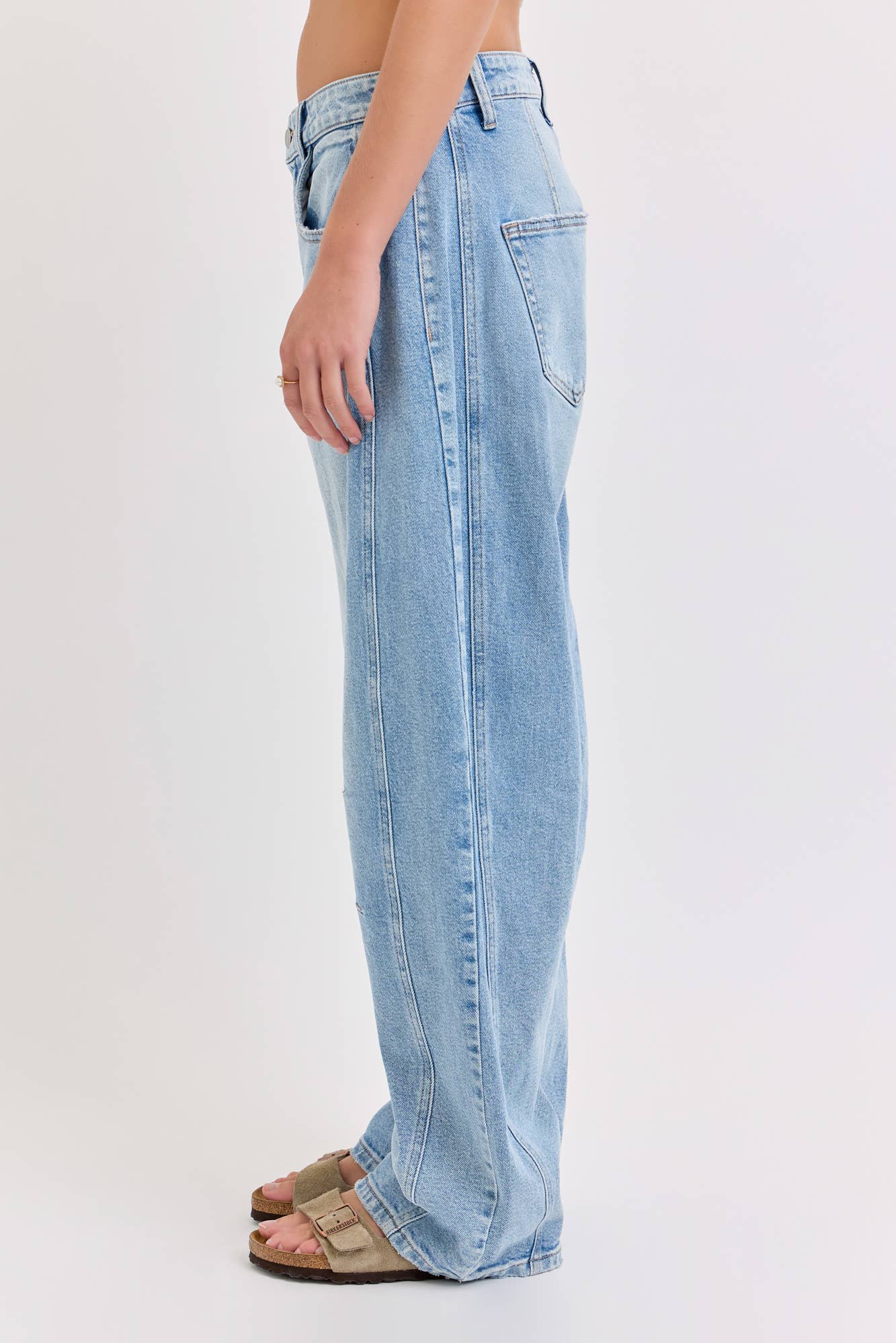 Light blue jeans worn by a person on a white background