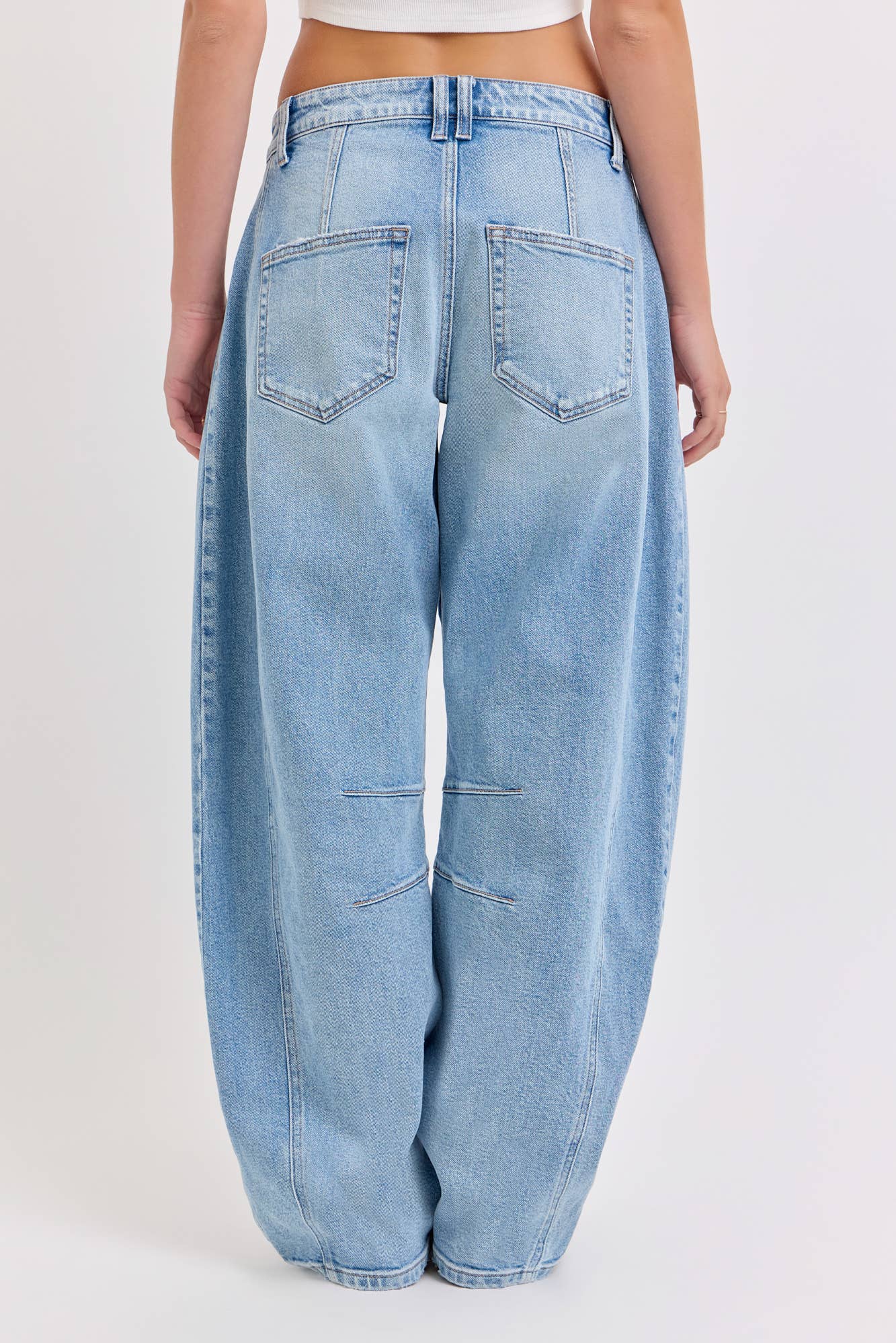 Light blue jeans worn by a person on a white background