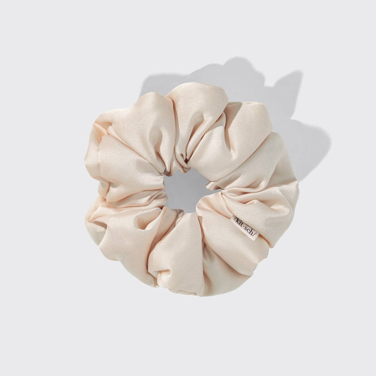 Beige scrunchie on a light gray background