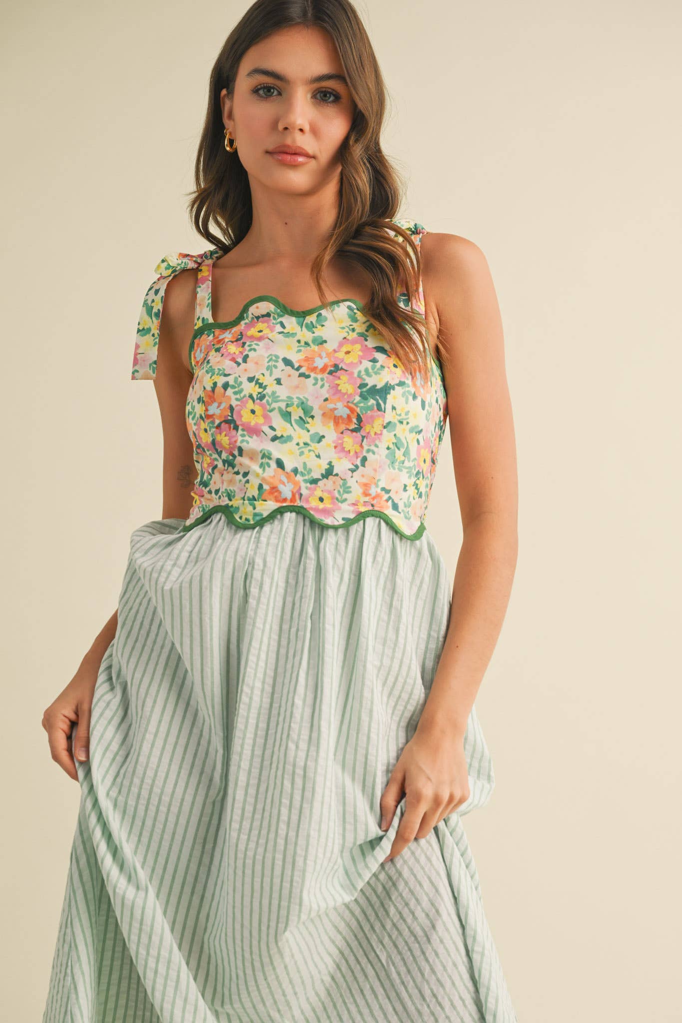 Floral bodice midi dress with sage striped skirt, tie straps, and scalloped trim details.