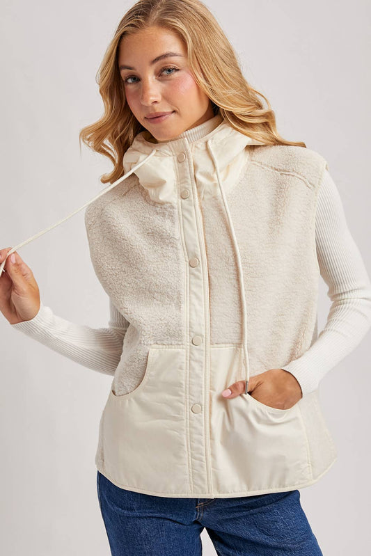 Soft cream sherpa vest layered over ribbed ivory turtleneck
