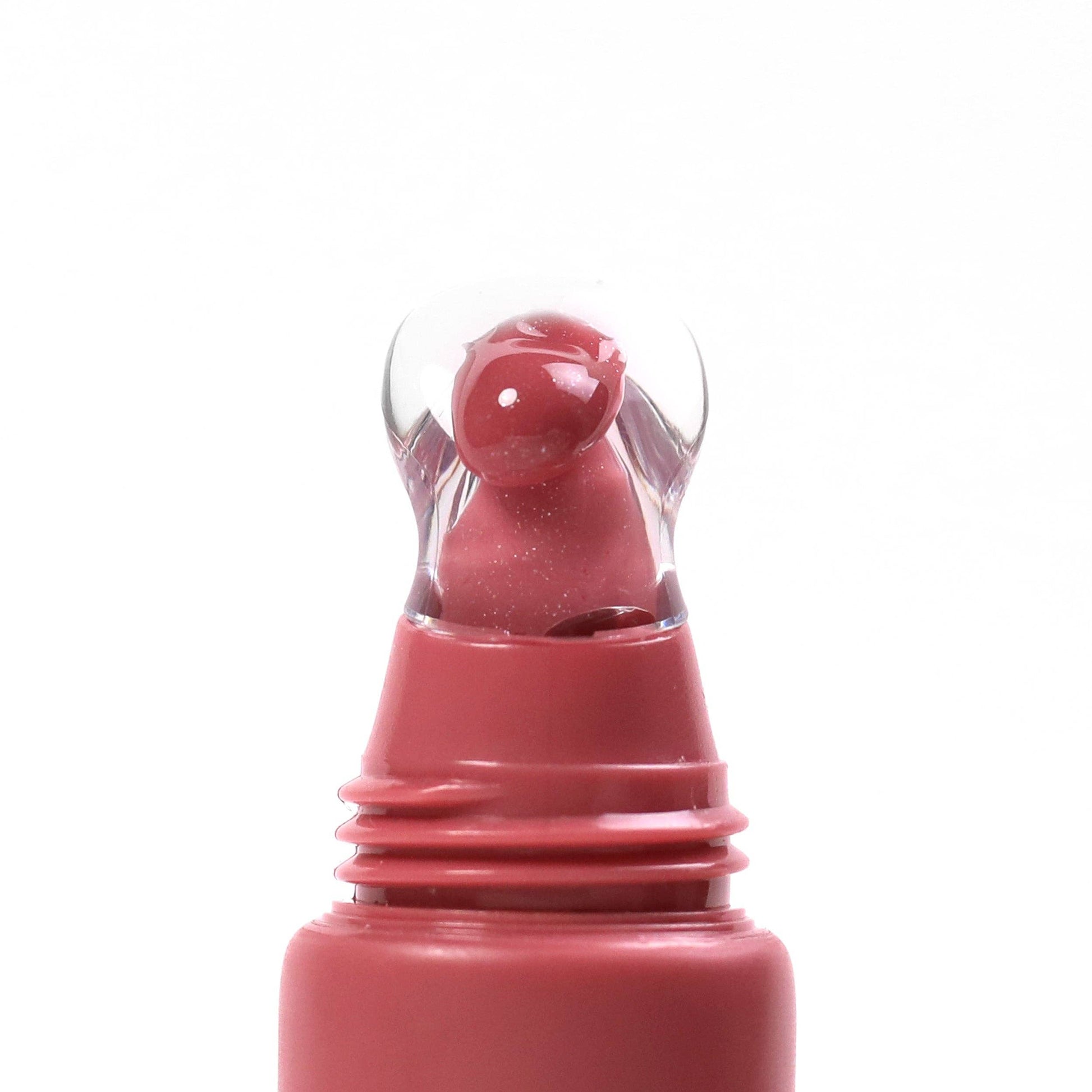Pink lip gloss with clear cap on a white background